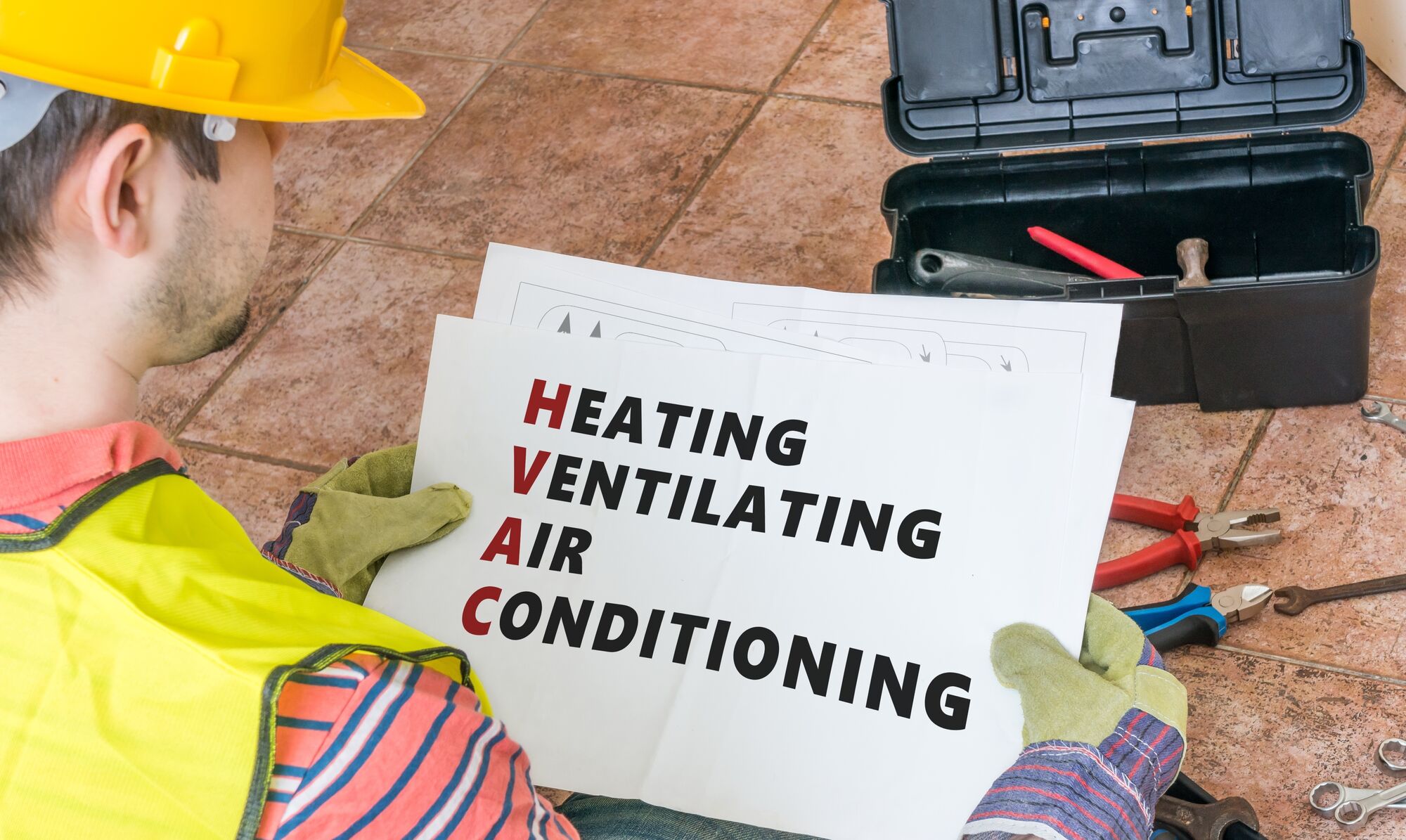 Man holding a HVAC on a paper